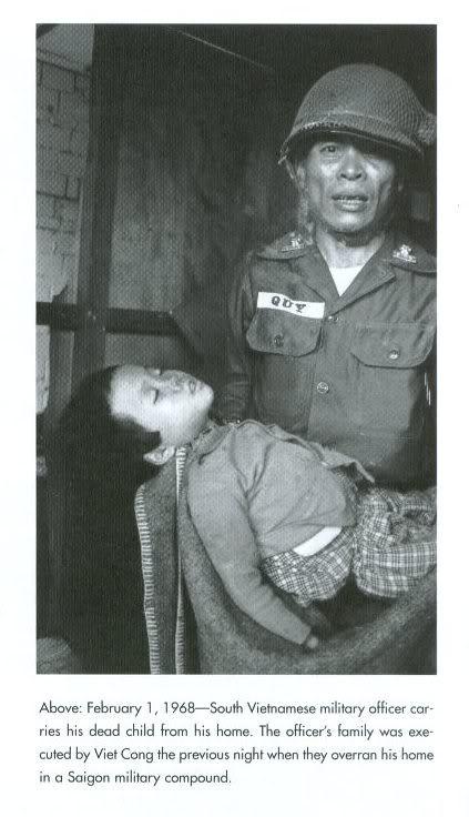 A South Vietnamese officer carrys the body of his son after he was executed in his home by the Viet Cong during the Tet Offensive. February 1, 1968. [423 × 736].
