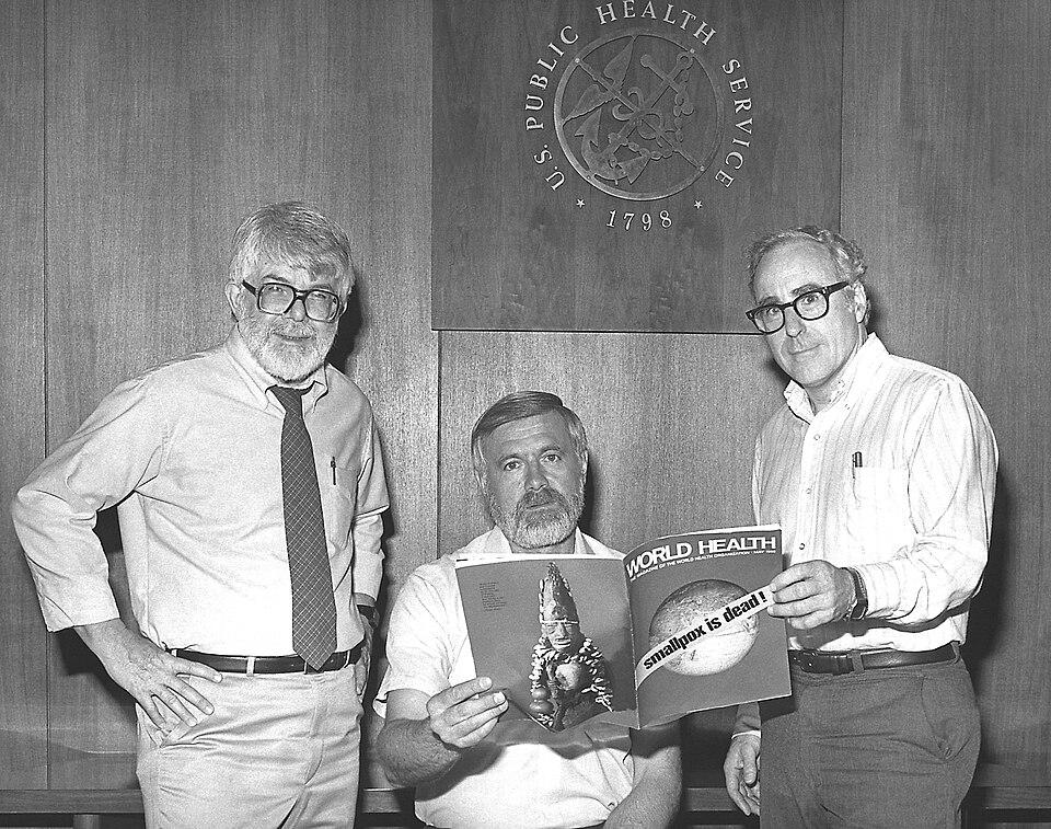 Drs. J. Donald Millar, William H. Foege and J. Michael Lane, directors of the Global Smallpox Eradication Program, reading the news at the Center for Disease Control about the eradication of smallpox. Atlanta, Georgia, United States. 1980 [761×600]
