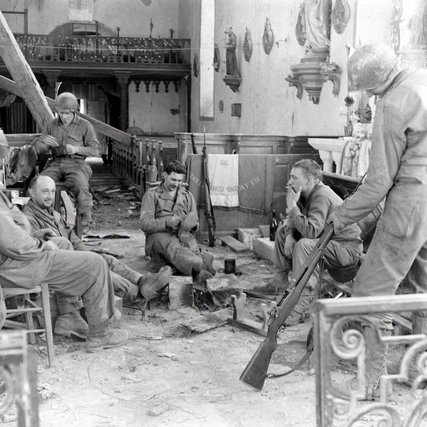 GIs take a break and clean their weapons in the damaged church of Saint-Georges in Saint-Georges-d’Elle during the Battle for Hill 192 in Normandy, July 1944. (Frank Scherschel Photo for LIFE Magazine) [1440×1440]