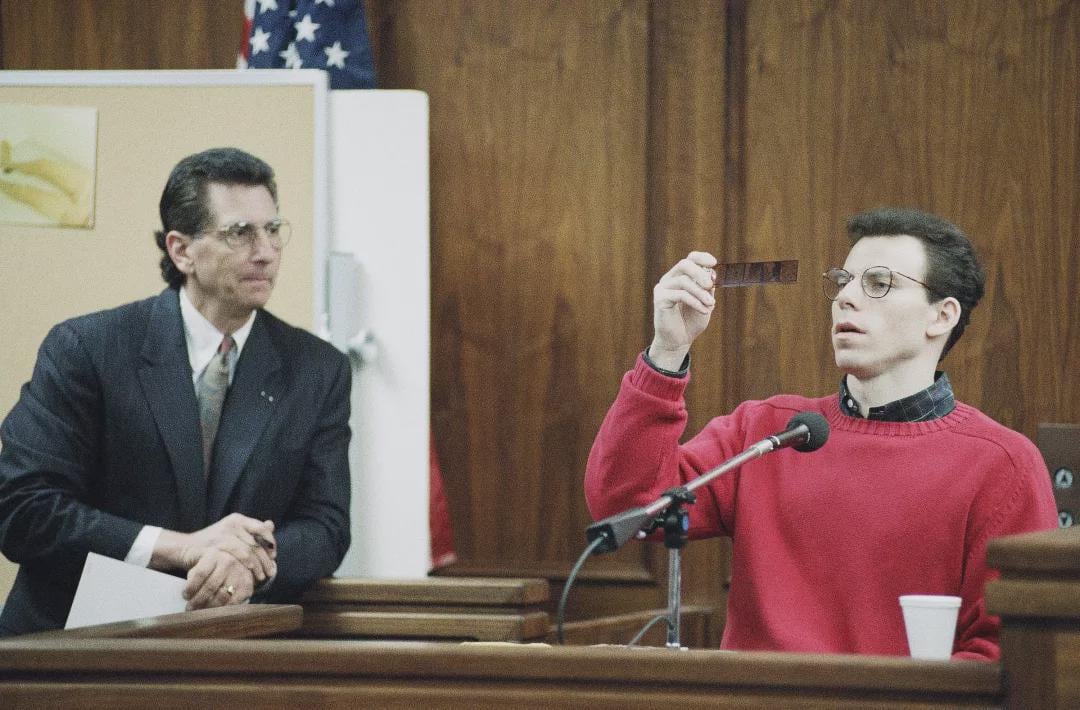 Erik Menendez, 25, looks at negatives of photos taken by his father, Jose, of him when he turned six and was nude. Lawyers for Erik and his brother, Lyle, used this as evidence that the men had killed their parents after years of sexual abuse (California, 1992) [1080 x 710].