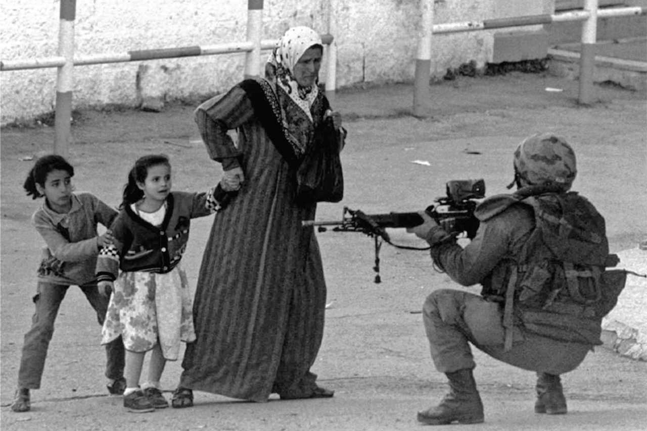 A Palestinian woman pleads with an IDF soldier to allow her and her children to cross a checkpoint in Hebron, 31 October, 2001. [1280 x 854]