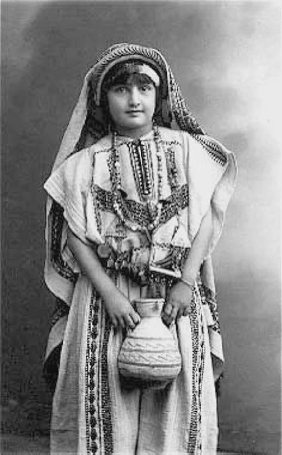 A Palestinian girl wearing traditional attire of the town of Ramallah, 1932 [604 × 1000]