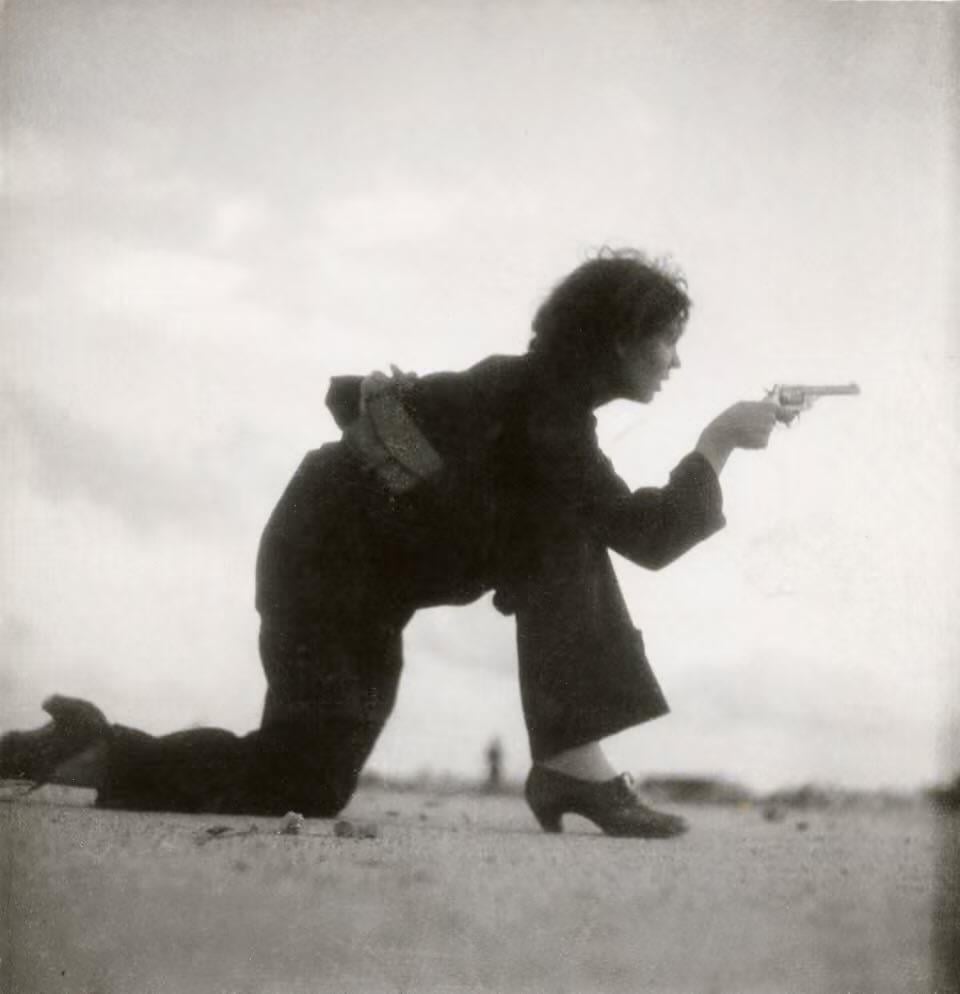 Militia member from the Republican side – on Somorrostro beach in Barcelona – during the Spanish Civil War, c. 1936. The Photo was taken by German photographer Gerda Taro. [960 x 994]