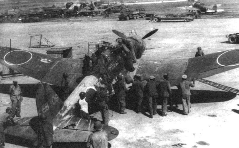 U.S. personnel move a Japanese Nakajima B5N2 “Kate” carrier-based torpedo bomber, with an H-6 radar — it was captured at Saipan airfield, during the Battle of Saipan, c. June – July 1944. [800 x 498]