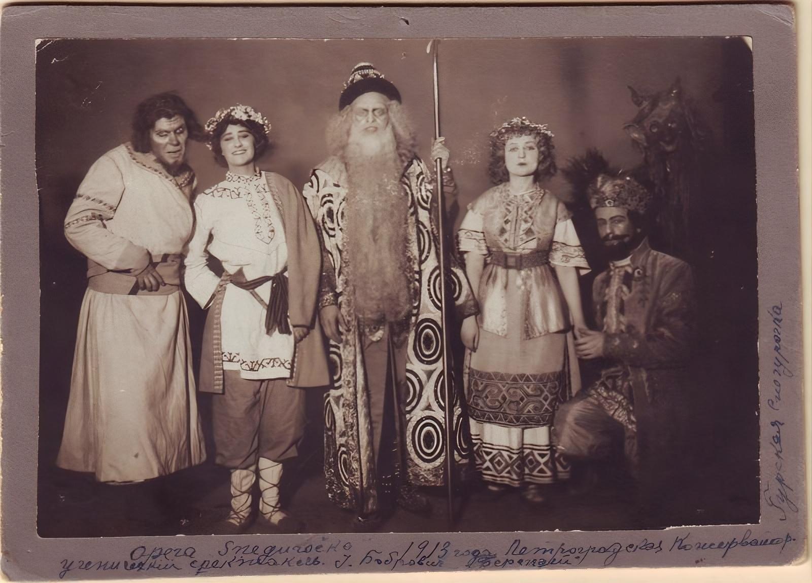 1913.  The cast of the opera “Snegurochka” (“The Snow Maiden”) poses for a photo after a performance at the St. Petersburg Conservatory.  The man in the center is Juozas Babravičius, a Lithuanian operatic tenor, in costume as Tsar Berendey. [1600 x 1150]
