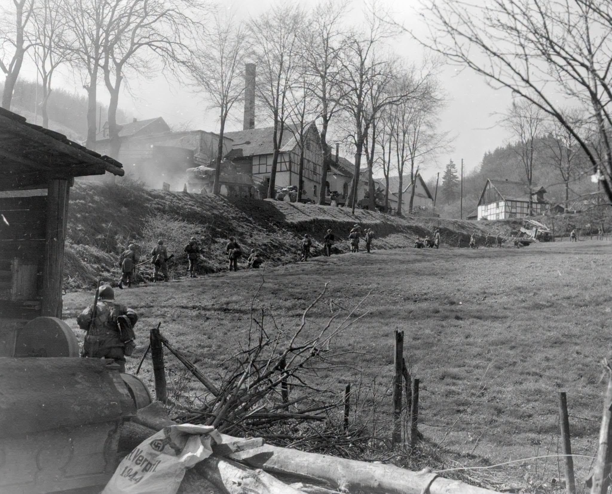 GIs of the 5th Division, skirt the newly-taken town of Grevenstein, Germany, to attack a nearby hill which the Germans are using for an observation post. 11 April, 1945. Company K, 2nd Infantry Regiment, 5th Infantry Division. (Photographer: Pfc. Jerome P. Musae, Signal Corps.) [2048×1659]