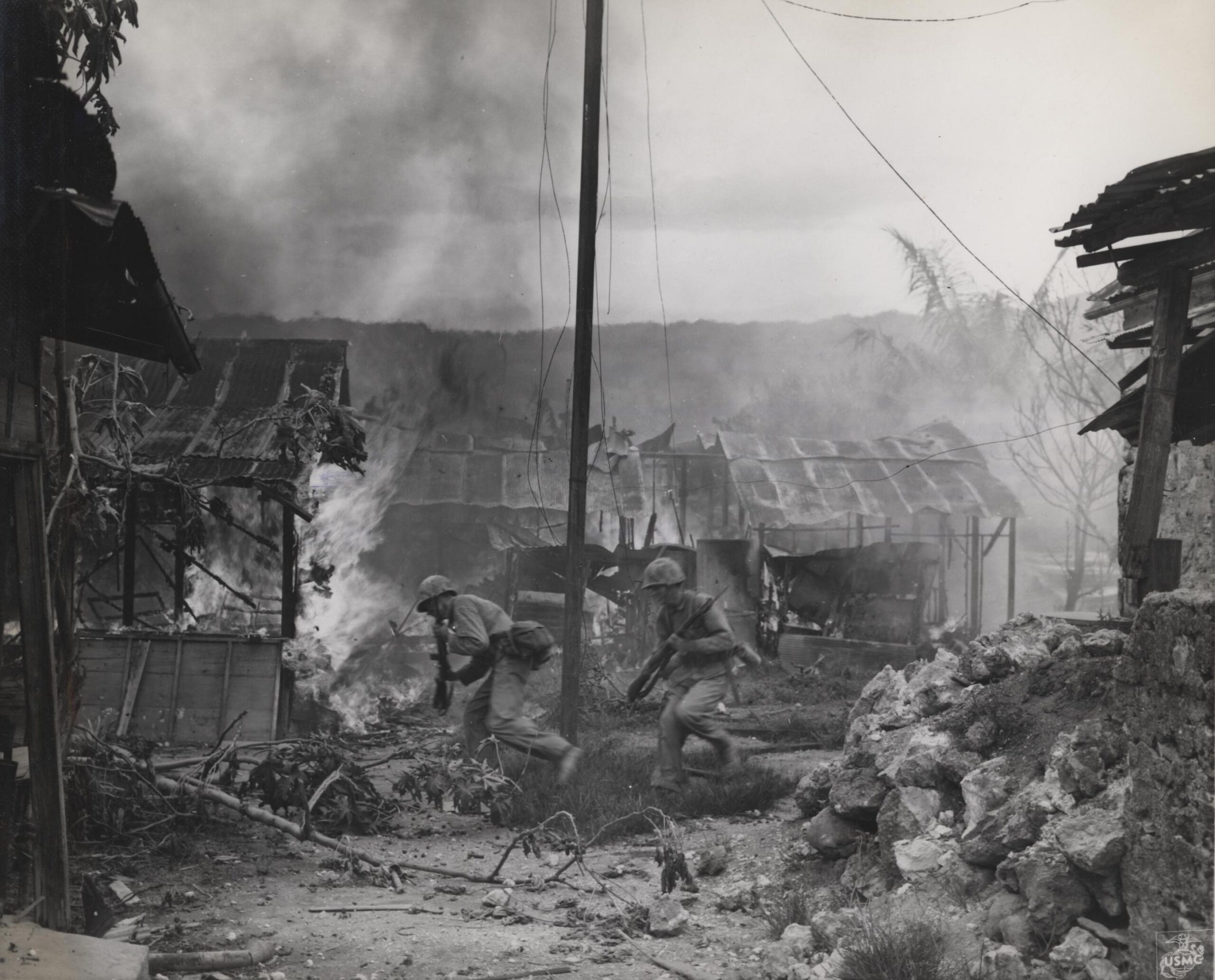 U.S. Marines advancing through burning buildings in Garapan, Saipan. 3 July 1944 [2876 × 2320]