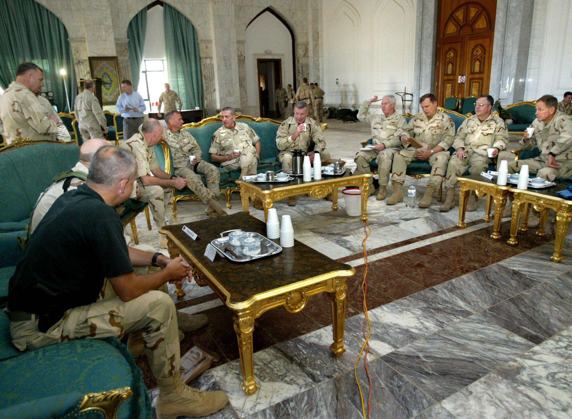 Members of the US military gather for a meeting inside one of Saddam Hussein’s palaces during the US invasion of Iraq. (2003) [2000×1467]