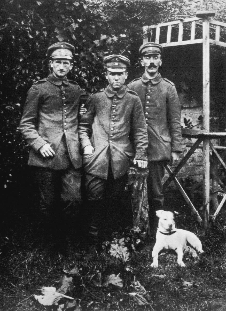 Adolf Hitler, 2 fellow comrades and his beloved stray dog, Fuchsl (Little Fox), that he had rescued after Fuchsl chased a rat across No Man’s Land and ended up in the German trenches where he was stationed, near the Village of Fromelles – WW1, 1915. [875×1204]