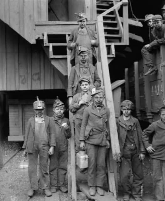 “Breaker boys” posing on the steps of the Ewen Breaker at the Pennsylvania Coal Co., South Pittston, Pennsylvania, January 1911. Photo by Lewis Hine [526×640]