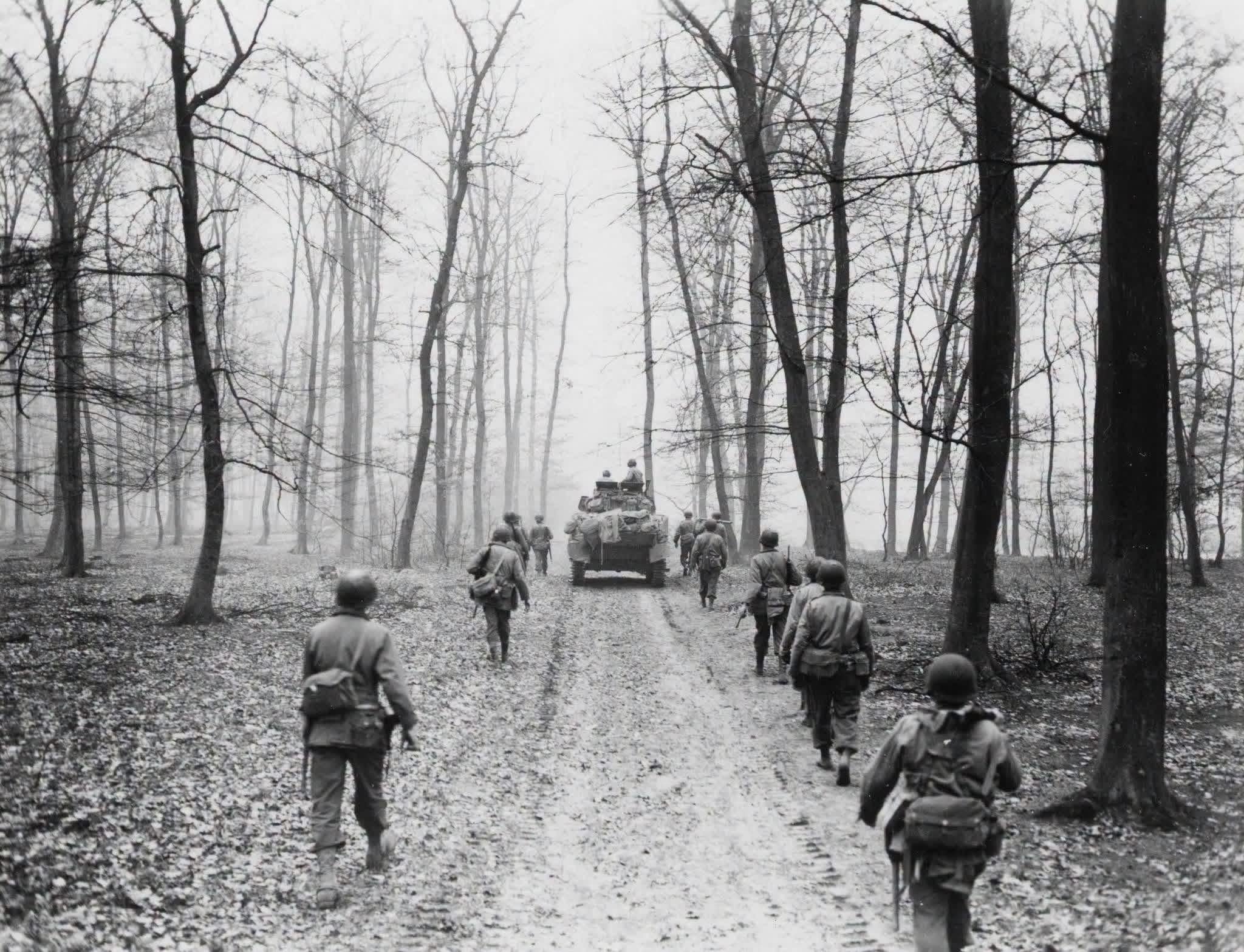 GIs of the 5th Infantry Division move up through the woods outside Neuheim, enroute to Schweinheim, Germany, with tank support. March, 1945. Photograph by Capt. Leo Lieb, US Signal Corps. [2048×1567]