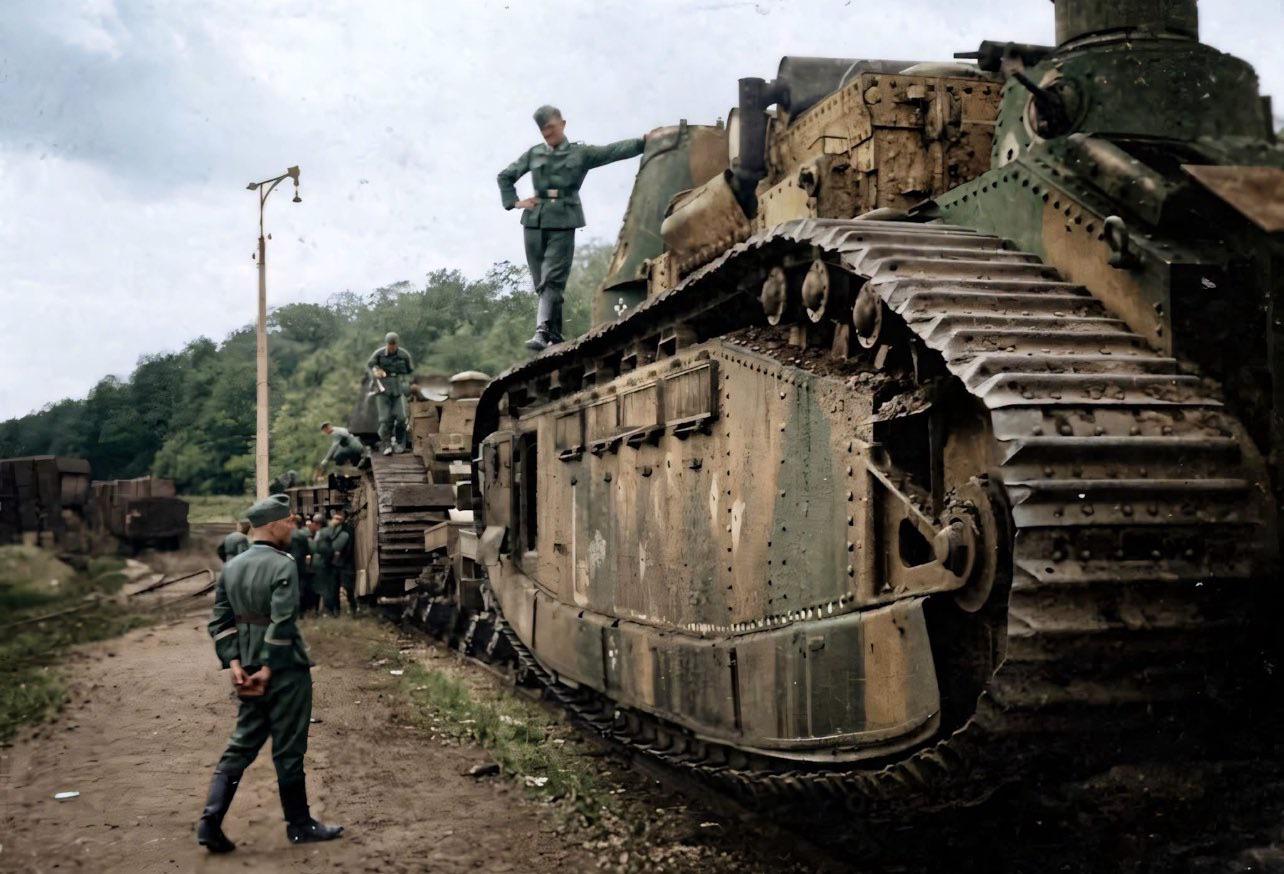 Soldiers from the Wehrmacht with two captured French Char 2C super-heavy tanks, near Meuse-sur-Meuse, during the final weeks of the Battle of France, c. June 1940. [1284 x 874]