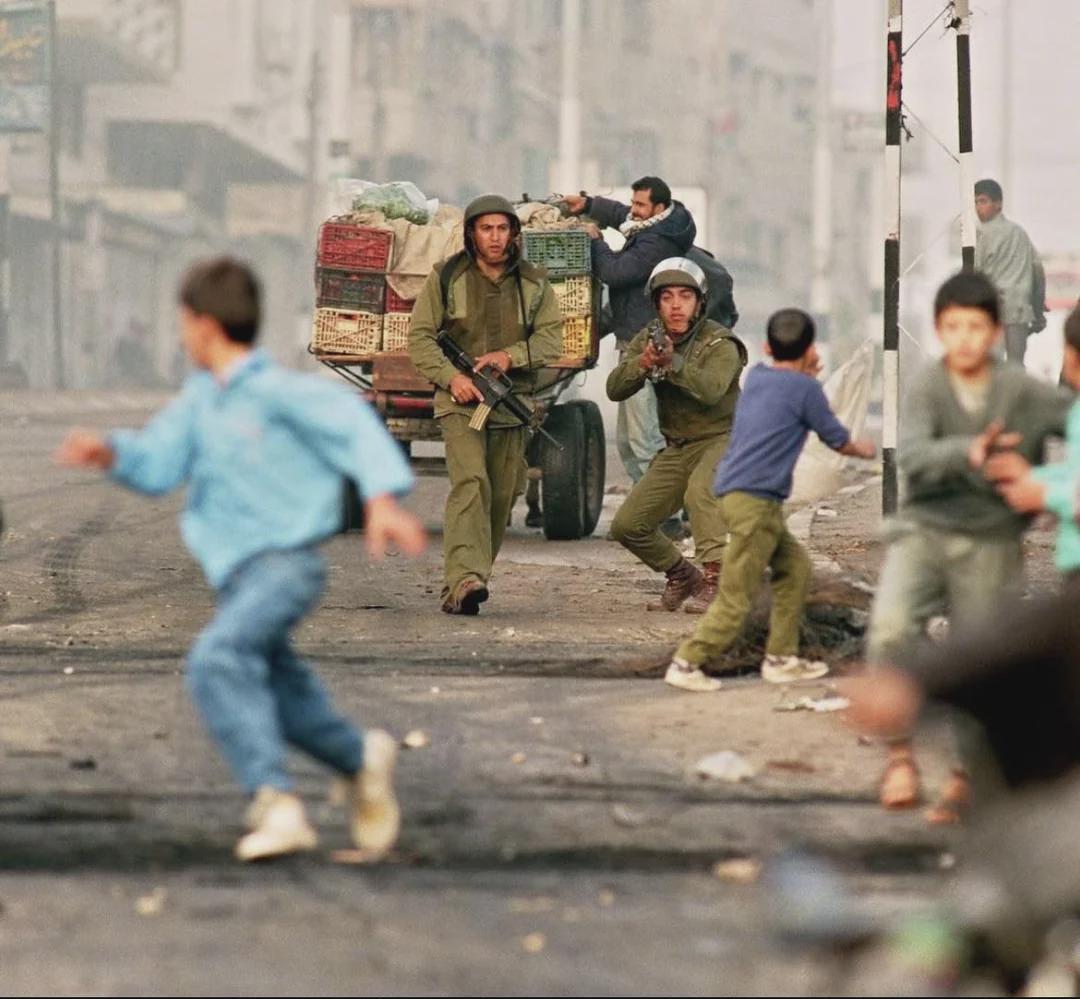 Palestinian children running away from open fire, 1993. [1080×999]