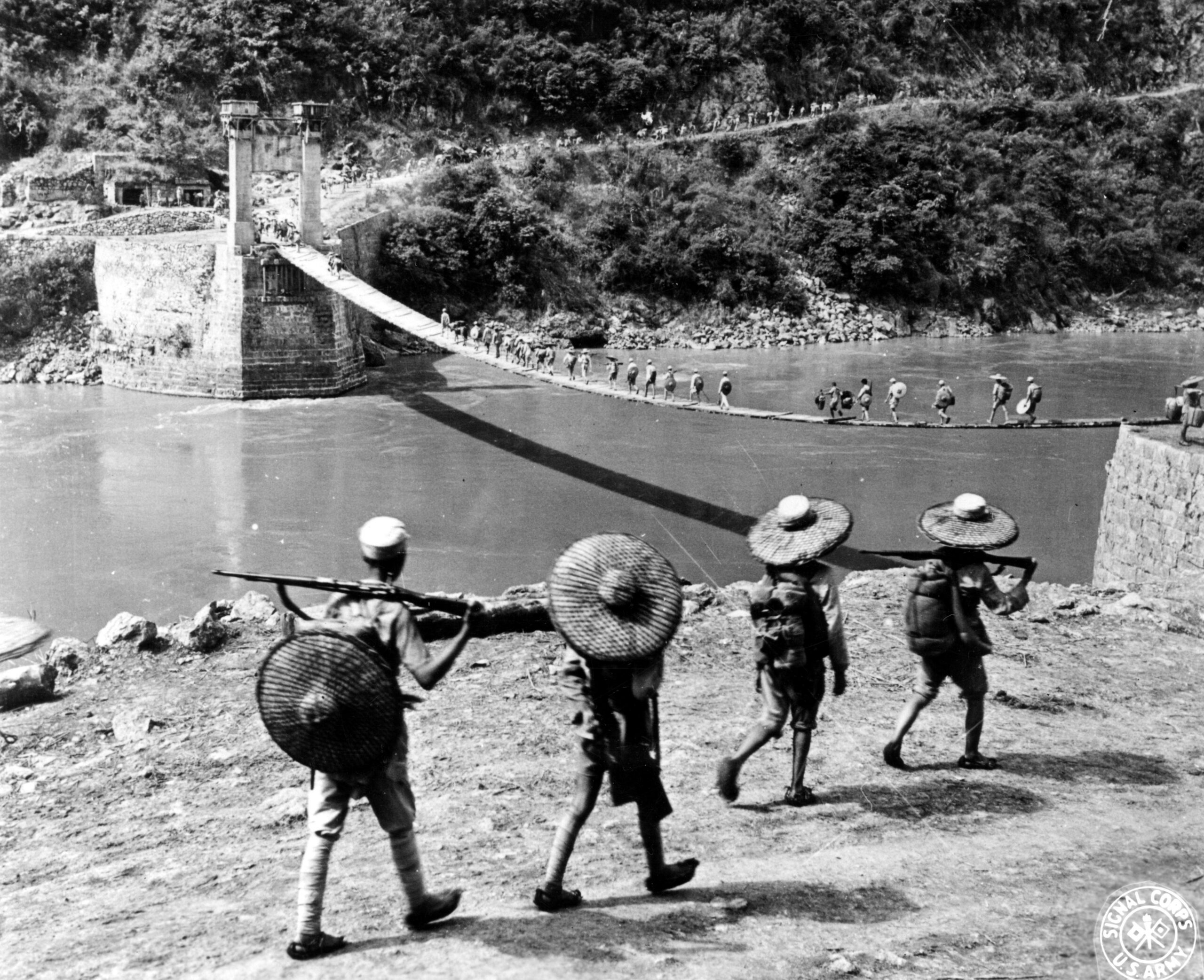 Chinese soldiers crossing the Salween River by means of temporary suspension bridge. The bridge was blown up two years ago by retreating Chinese forces. 15 July 1944 [5090 × 4145]