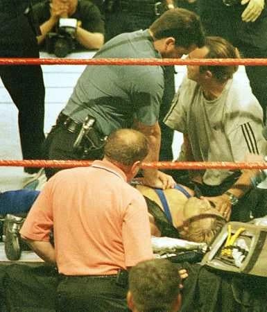 EMS and WWF staff giving medical attention to wrestler Owen Hart – after he accidentally fell 78 ft into the ring, at the “Over the Edge” pay-per-view, at the Kemper Area in Kansas City, Missouri – May 23rd, 1999. [385 x 450]