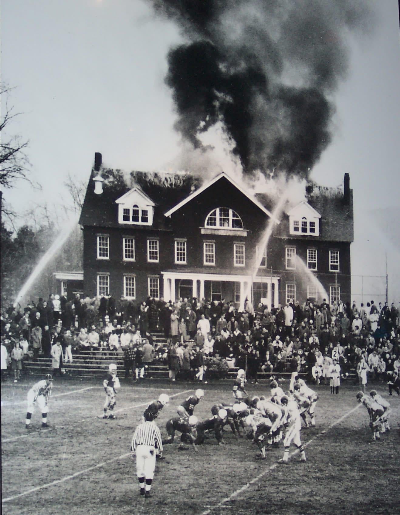 “Priorities” – Taken by Associated Press photographer Robert S. Van Fleet, shows a November 1965 football game between Northfield Mount Hermon School and Deerfield Academy in Massachusetts. The burning building in the background is Silliman Hall, a science building on the NMH campus. [1318×1697]