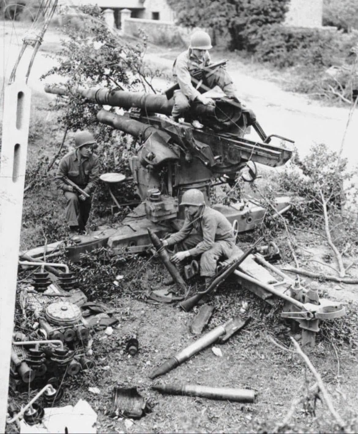GIs of the 4th Infantry Division inspect a knocked out German 8.8cm Model 36 Flak gun in Cherbourg, France, July, 1944. [1170×1408]