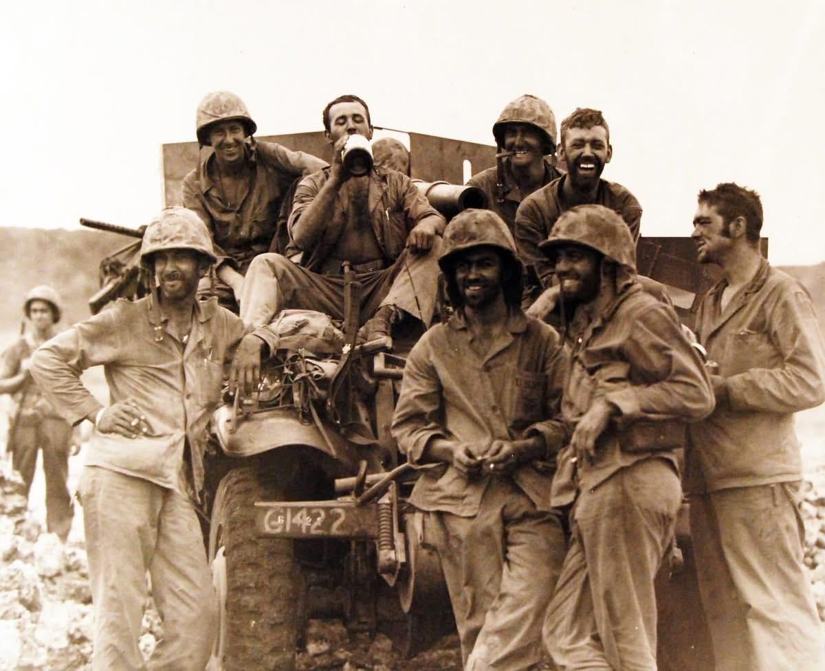 U.S. Marines resting after hunting snipers in caves along northern Saipan coast line near Marpi Pt., 10 July 1944. Photographed by USS Indianapolis (CA 35) photographer. [1200×977]