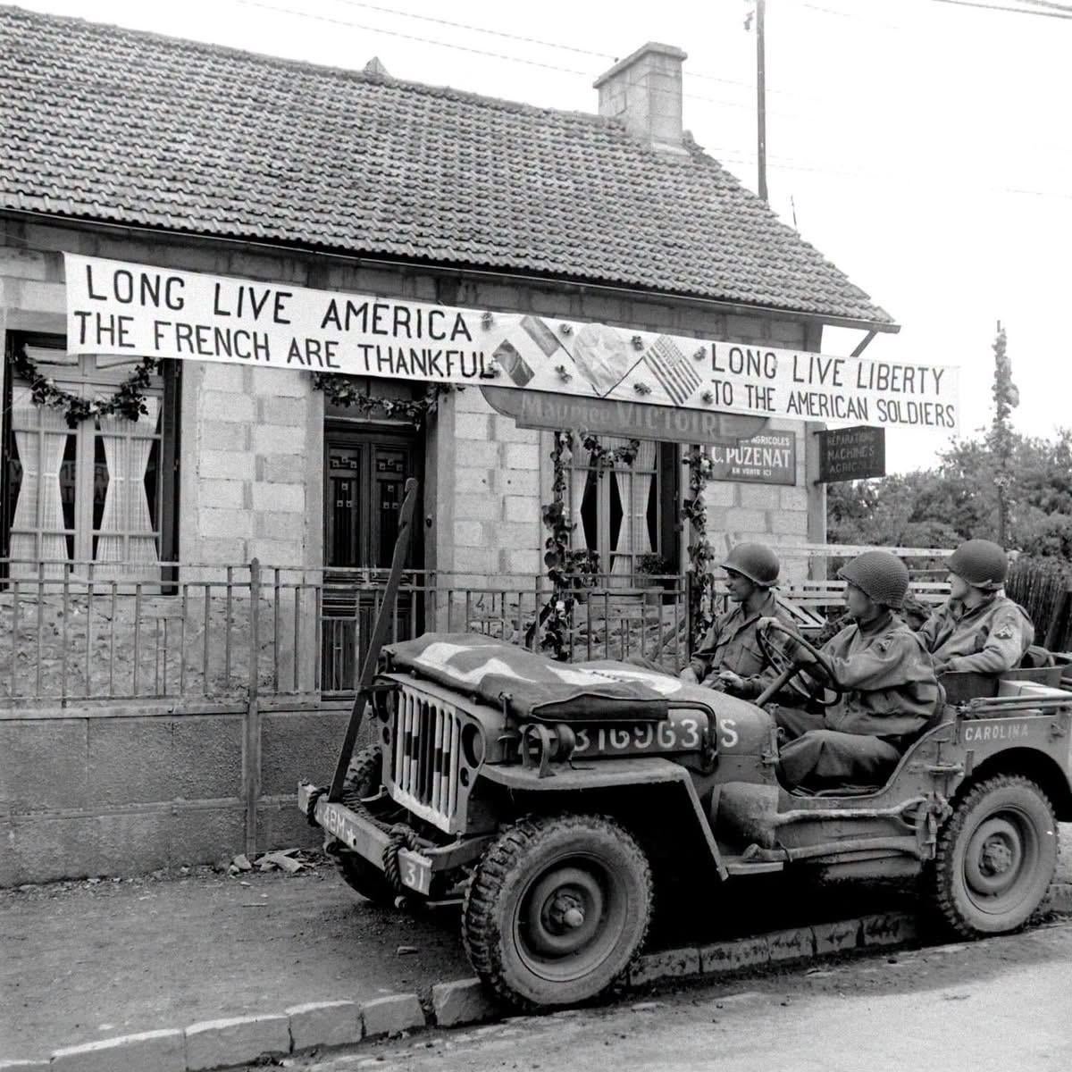 Personnel with the 48th Armored Medical Battalion, US 2nd Armored Division, in a jeep stop to look at a sign thanking them in Le Molay-Littry, Normandy – July 4, 1944. (Frank Scherschel Photographer LIFE Magazine) [1200×1200]