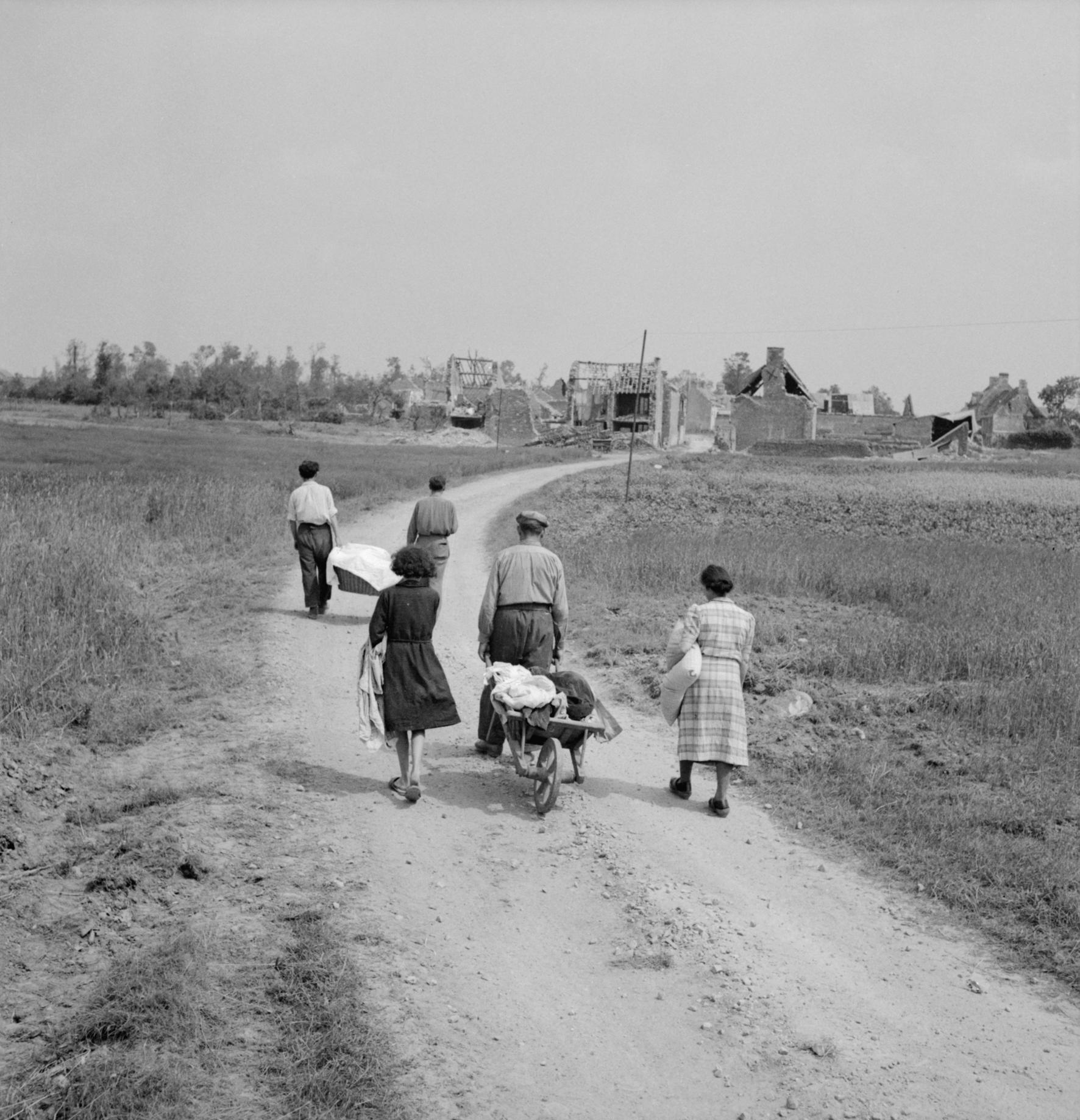 A French family returns to their village, Buron, northwest of Caen, which was completely wrecked during the fighting. Normandy, France, 18 July 1944 [1772 × 1837]
